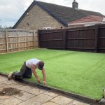 Installing fake grass in a garden in cavan